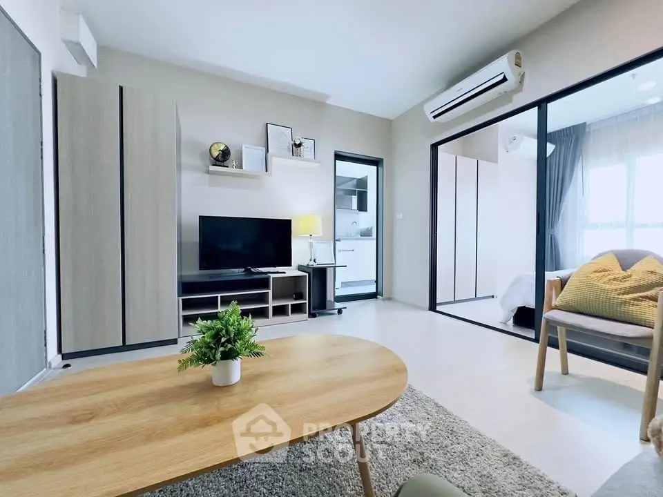 Modern living room with sleek furniture and open layout, featuring a cozy ambiance and stylish decor.