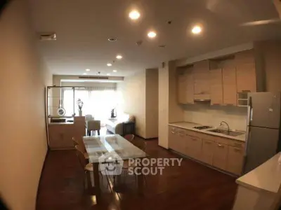 Spacious open-layout kitchen and dining area with modern appliances and wooden flooring.