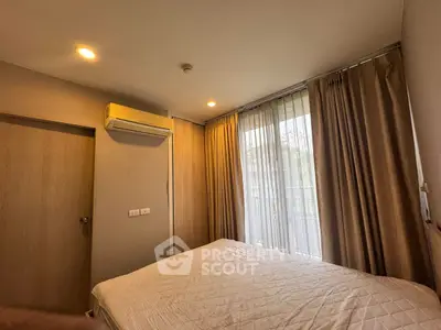 Cozy bedroom with natural light and modern air conditioning unit.