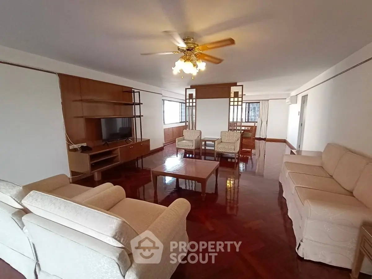 Spacious living room with elegant wooden flooring and cozy seating area