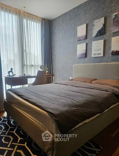 Modern bedroom with stylish decor and natural light, featuring a cozy bed and a sleek study desk by the window.