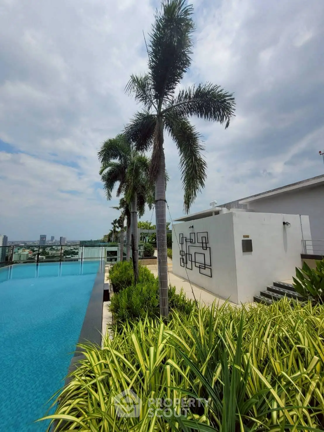 Luxurious rooftop pool with stunning city views and lush greenery