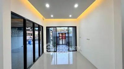 Modern interior with sleek glass doors and recessed lighting, perfect for contemporary living.