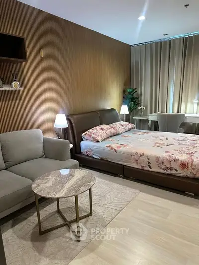 Modern bedroom with stylish decor, featuring a cozy bed, elegant sofa, and chic lighting for a luxurious ambiance.