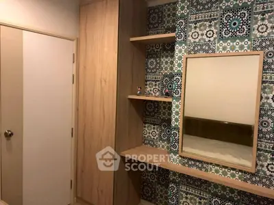 Stylish bedroom corner with patterned wall and mirror