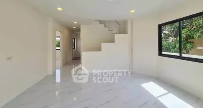 Spacious modern living room with marble flooring and large window view