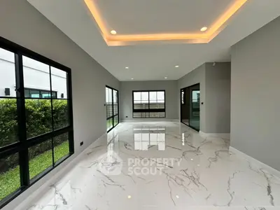 Spacious modern living room with marble flooring and large windows
