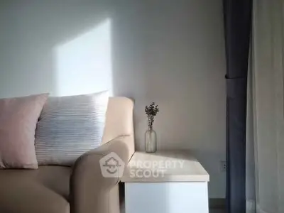 Cozy living room corner with beige sofa and soft lighting
