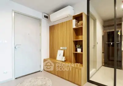 Modern apartment entrance with stylish wooden storage and air conditioning.