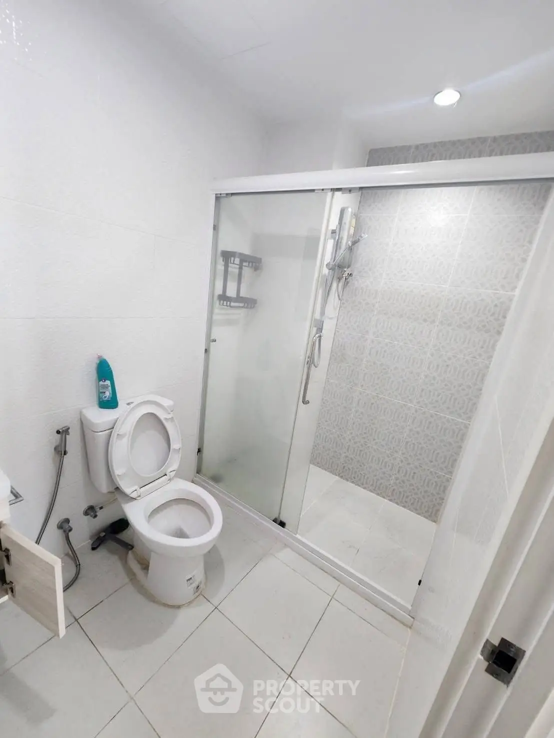 Modern bathroom with glass shower enclosure and white fixtures