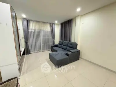 Spacious living room with modern sofa and elegant curtains