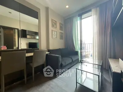 Modern living room with sleek furniture and large window for natural light.