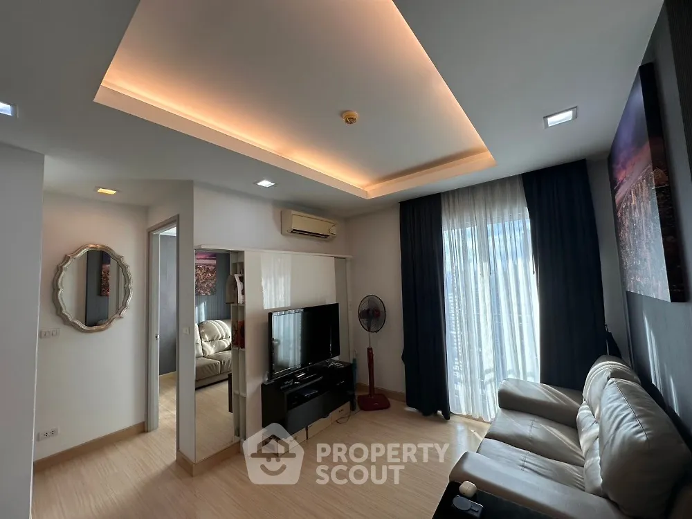 Modern living room with stylish ceiling lights and cozy leather sofa