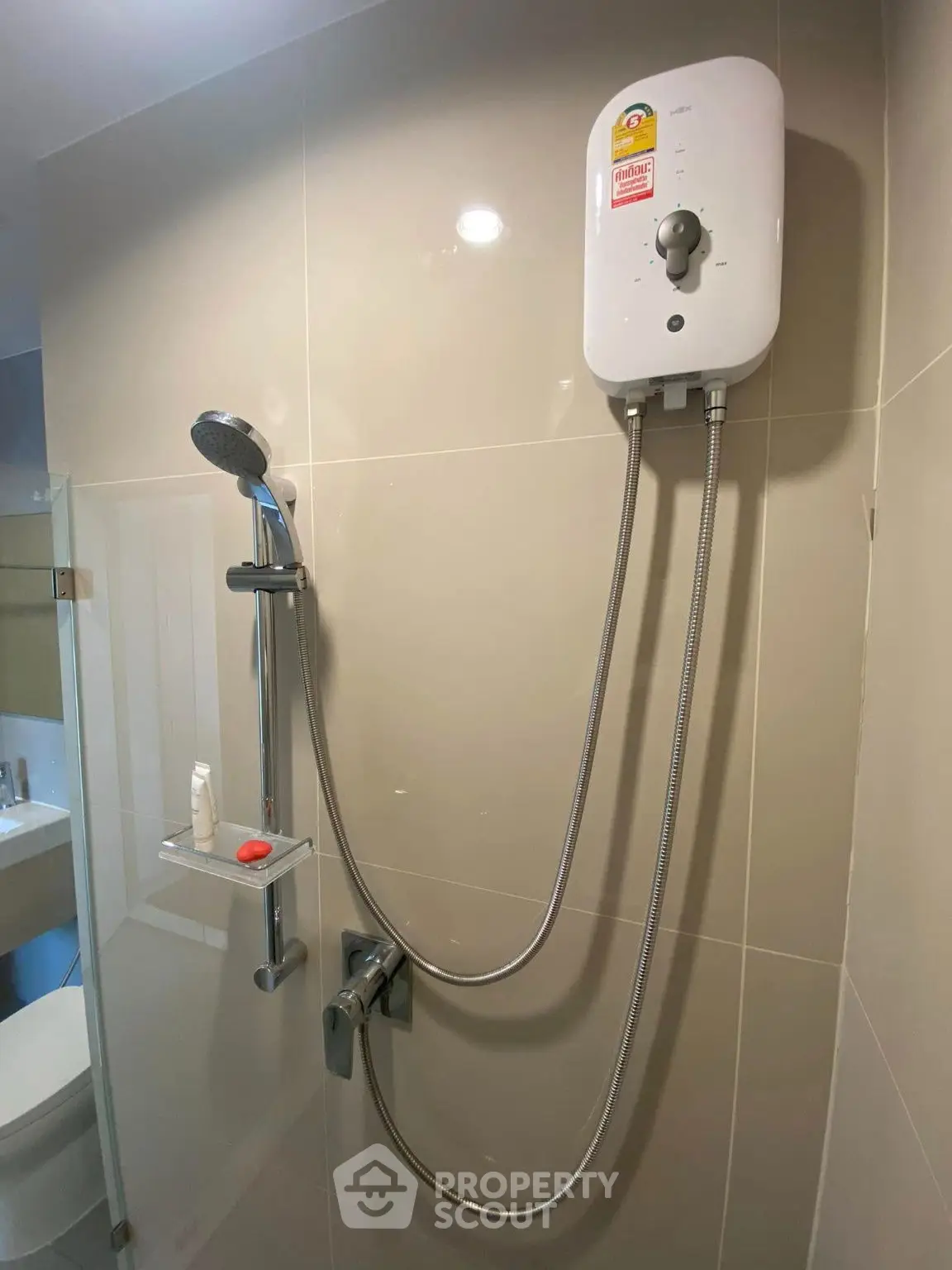 Modern bathroom with sleek shower and water heater, ideal for comfortable living.