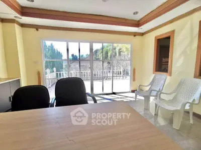 Spacious room with large windows and balcony access, perfect for natural light lovers.