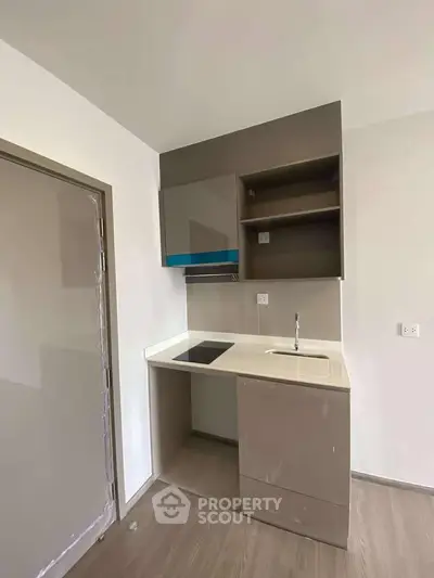 Compact modern kitchen with sleek cabinetry and integrated appliances