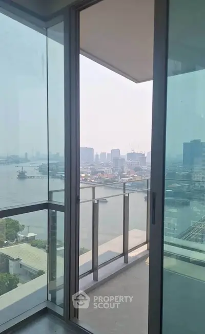 Stunning high-rise balcony with panoramic city and river views, perfect for urban living.