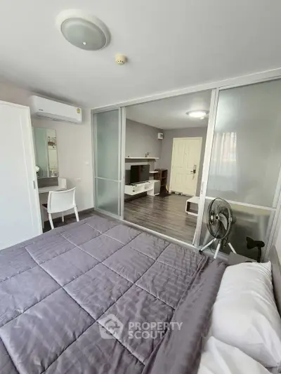 Modern bedroom with sliding glass doors and stylish decor