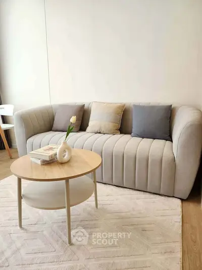 Modern living room with stylish sofa and chic coffee table, perfect for cozy relaxation.
