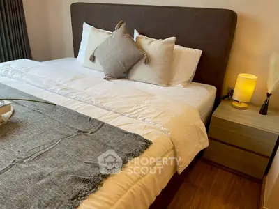 Cozy bedroom with plush bedding and stylish decor, perfect for relaxation and comfort.