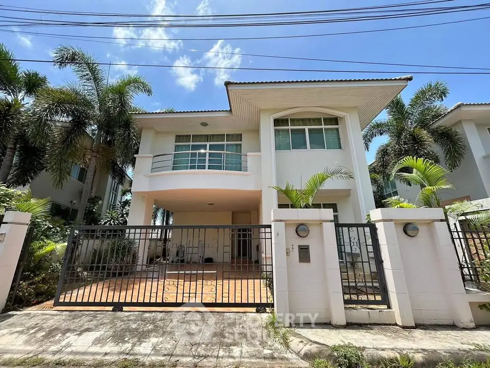 Stunning two-story house with modern design and lush palm trees, perfect for family living.