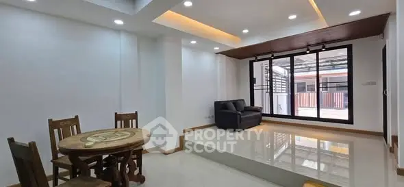 Spacious modern living room with elevated seating area and large windows