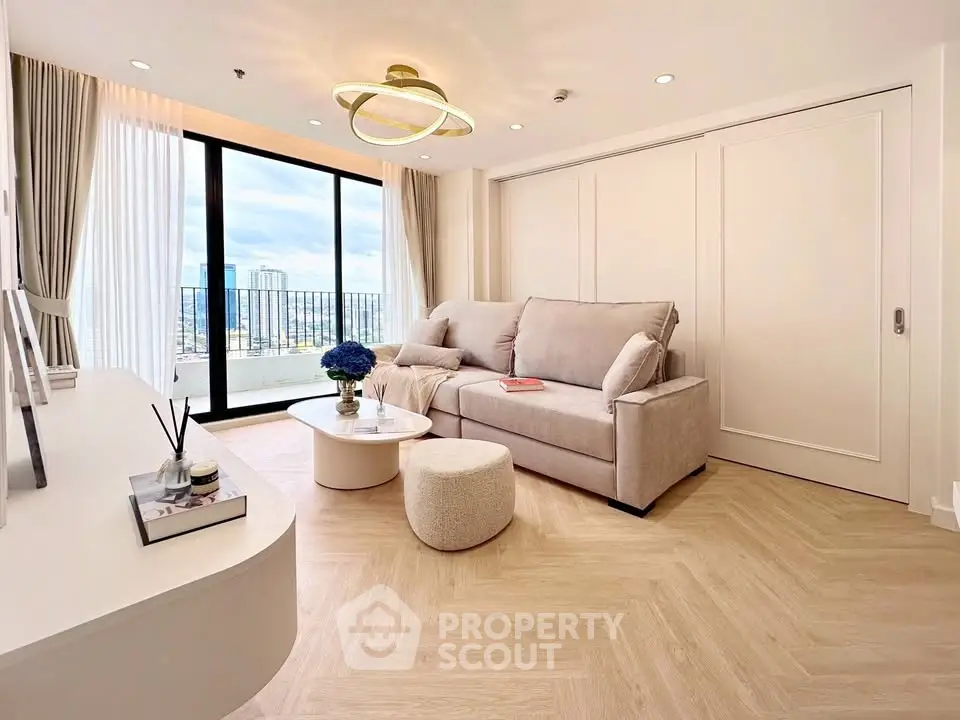 Modern living room with elegant decor and city view from large windows.