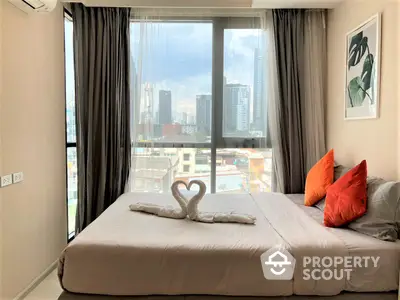 Cozy bedroom with a large comfortable bed, floor-to-ceiling windows offering a stunning city view, and tasteful decor, perfect for urban living.