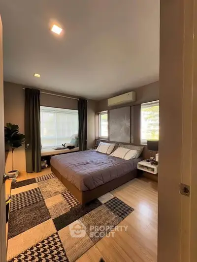 Spacious modern bedroom with large windows and stylish decor