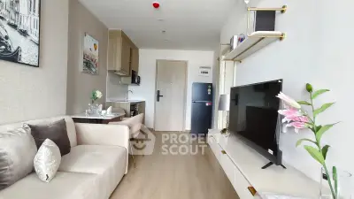 Modern living room with stylish decor and open kitchen layout in a cozy apartment.