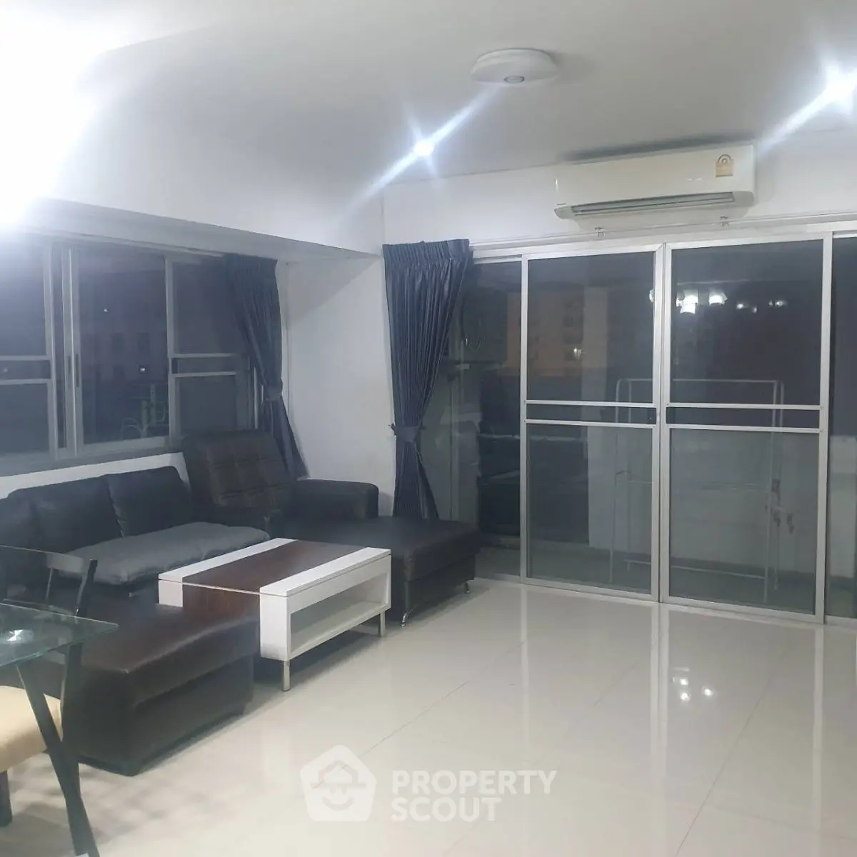 Spacious living room with modern furniture and large windows for natural light.