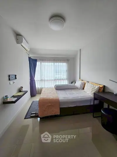 Modern bedroom with large window and minimalist decor