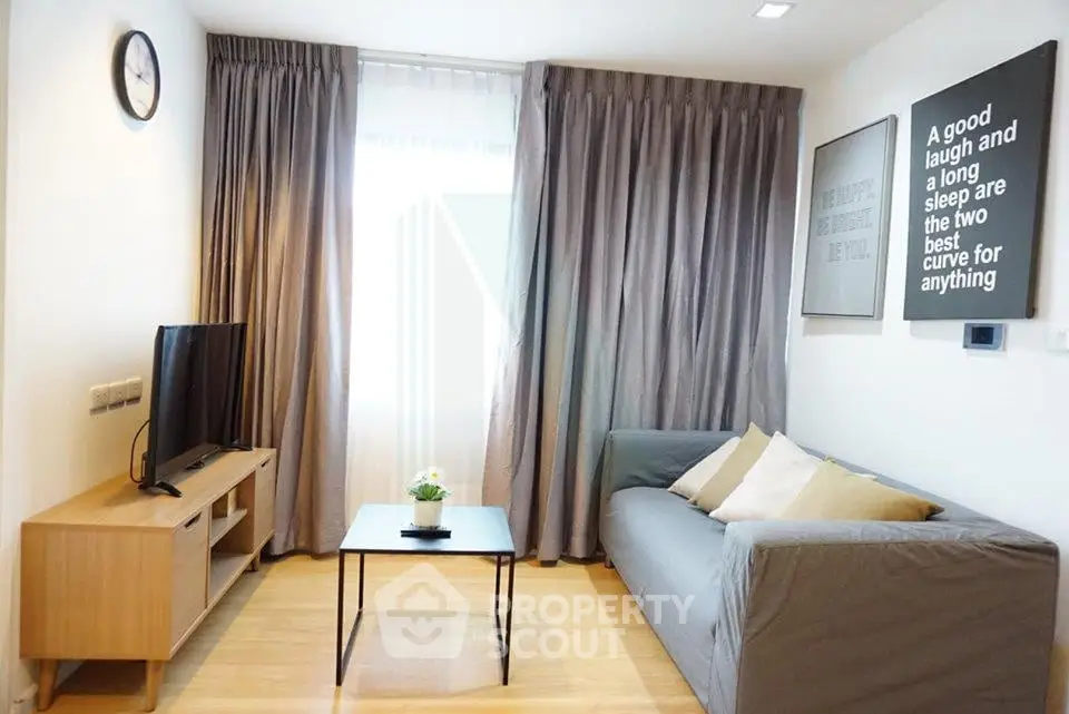 Modern living room with cozy sofa, TV, and stylish decor in a bright apartment.