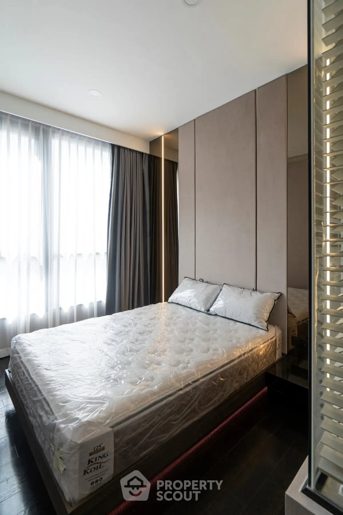 Modern bedroom with large window and stylish decor