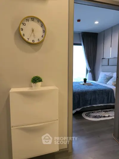 Modern apartment interior with stylish bedroom and decorative clock