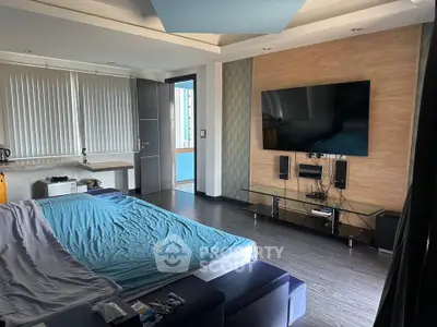 Modern bedroom with large TV and stylish decor