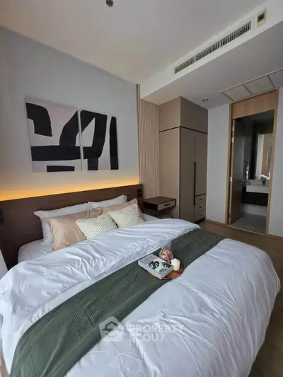 Luxurious bedroom with modern decor and cozy ambiance in a stylish apartment.