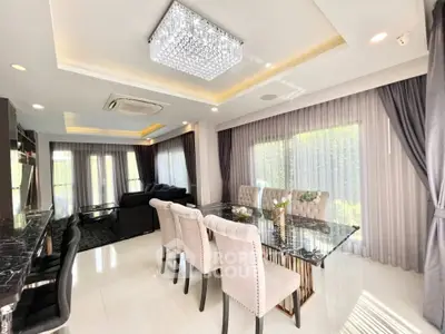 Luxurious open-plan living and dining area with elegant furnishings and natural light.