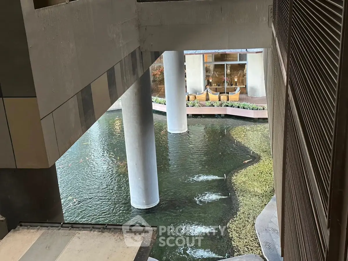Modern architectural design with water feature in urban building complex.