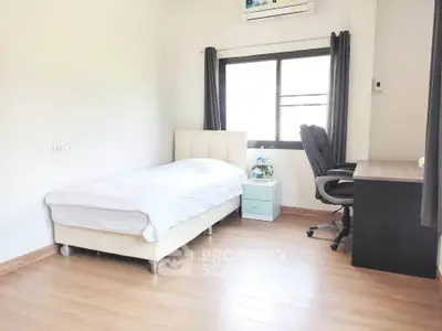 Bright and cozy bedroom with single bed and study desk, perfect for a minimalist lifestyle.
