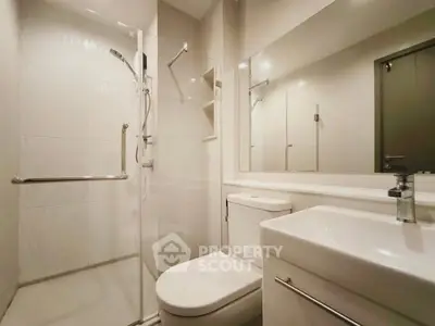 Modern bathroom with sleek fixtures and glass shower enclosure