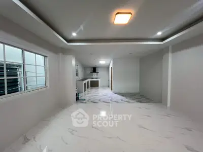 Spacious modern living room with open kitchen and elegant marble flooring