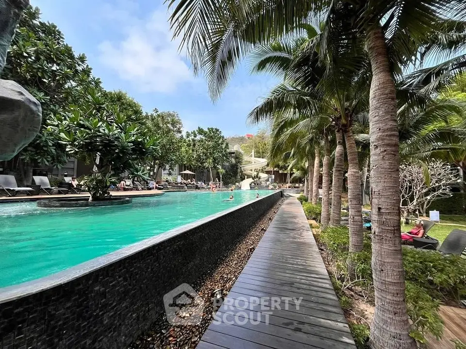 Luxurious tropical poolside oasis with lush greenery and palm trees, perfect for relaxation and leisure.