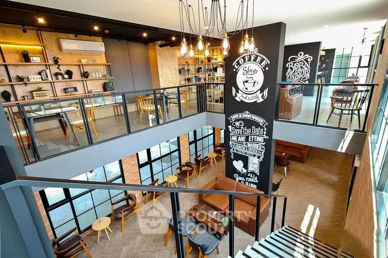 Modern two-story cafe with stylish interior and open seating area