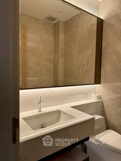 Luxurious modern bathroom with marble finishes and elegant lighting