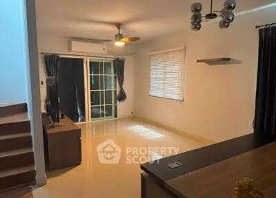 Spacious living room with modern decor and large windows for natural light.