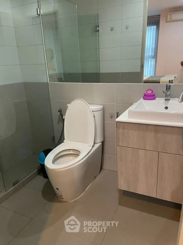 Modern bathroom with sleek fixtures and glass shower enclosure