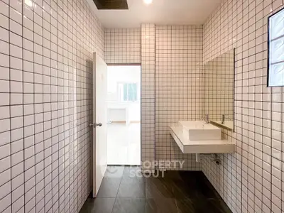 Modern bathroom with sleek white tiles and minimalist sink design