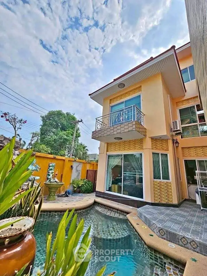 Stunning two-story home with private pool and lush garden, perfect for luxury living.