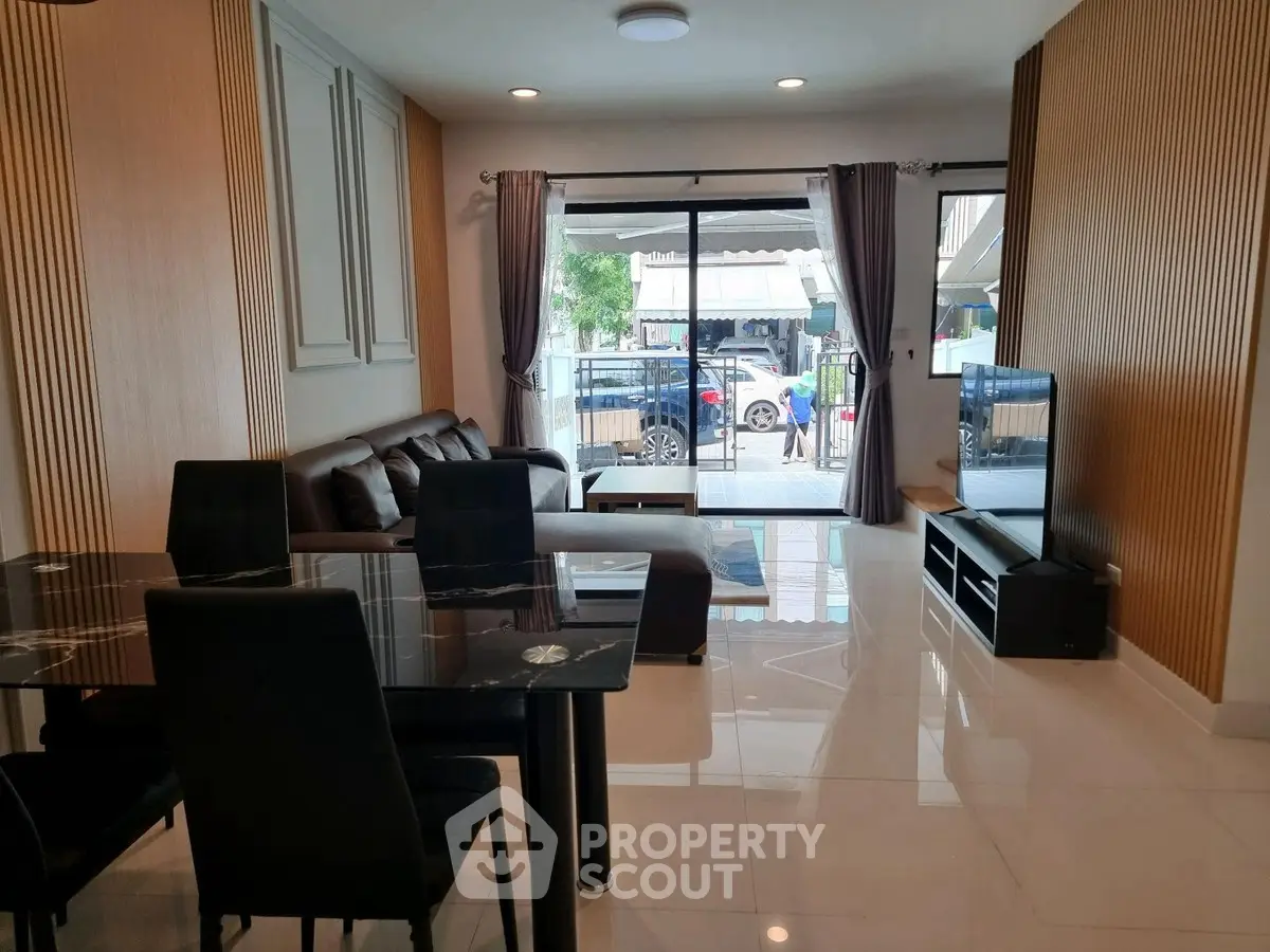 Modern living room with elegant dining area and large windows for natural light